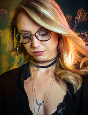 Pretty blonde lady looking down wearing glasses